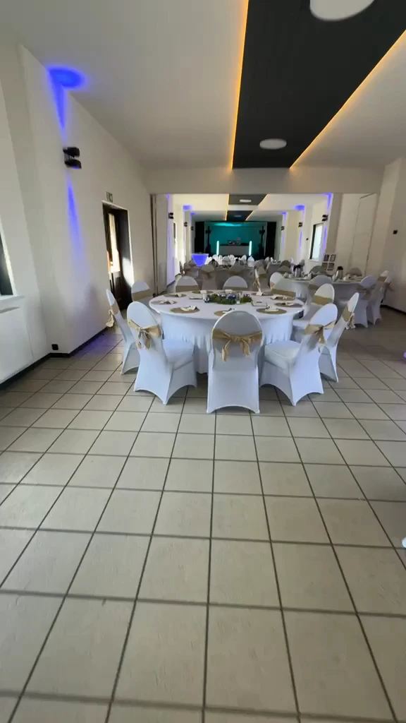 Standbild aus dem Hauptvideo: der Saal mit festlich gedeckten runden Tischen